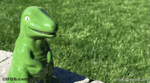 Green Dinosaur Figurine On Stone Wall GIF