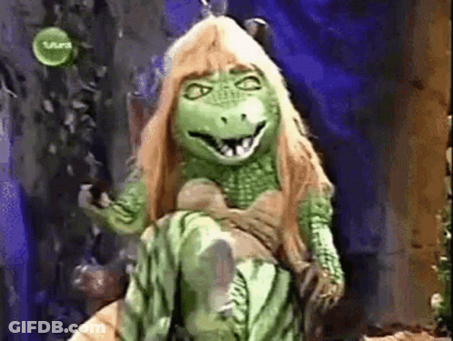 Green Dinosaur Mascot Sitting On Chair GIF