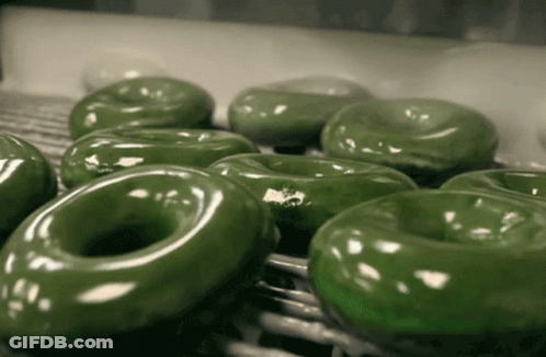 Green Donuts Sitting On A Shelf GIF