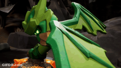 Green Dragon With Wings Standing On Rocks GIF
