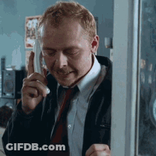 Green Frog In Pink Bow Tie Looking At Camera GIF