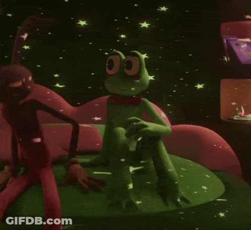 Green Frog In Red Bow Tie Sitting On Couch GIF