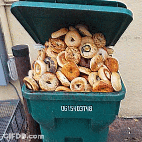 Green Garbage Can Filled With Bagels And Donuts GIF