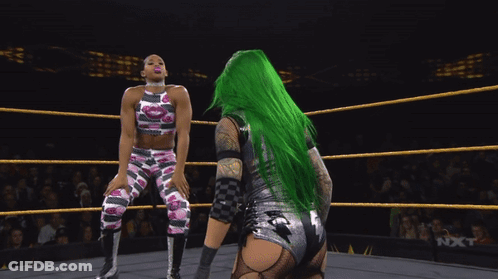 Green-Haired Female Wrestler Blowing Pink Bubble Gum GIF