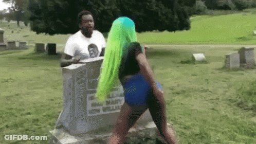 Green-Haired Woman Dancing At Grave In Cemetery GIF
