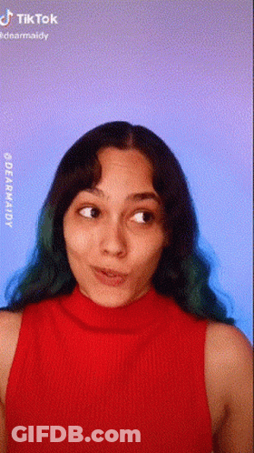 Green-Haired Woman Making Face In Red Tank Top GIF