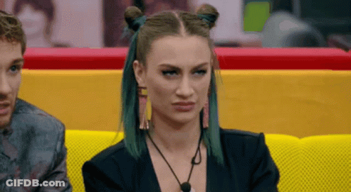 Green Haired Woman On Yellow Couch With Man GIF