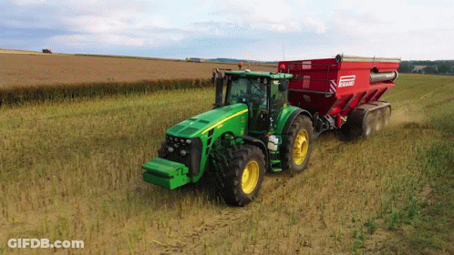 Green John Deere Tractor Pulling Red Bagger GIF