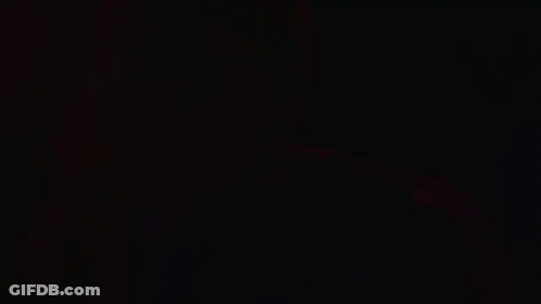 Green Light Shining Through Dark Room GIF