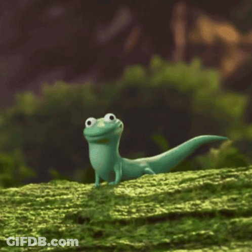 Green Lizard Standing On Mossy Hill GIF