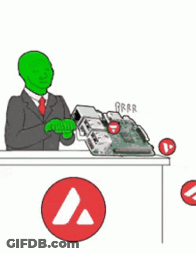 Green Man In Suit Sitting At Desk With Motherboard GIF