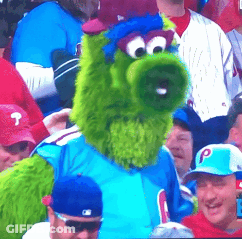 Green Mascot In Blue Shirt With Letter P GIF