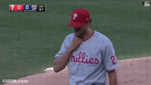 Green Mascot Standing In Front Of Crowd GIF