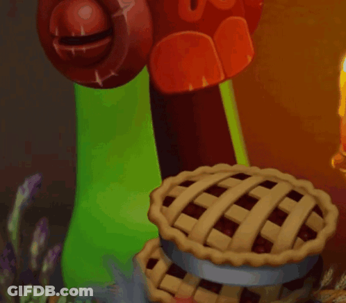 Green Monster Holding Pie Next To Candle GIF