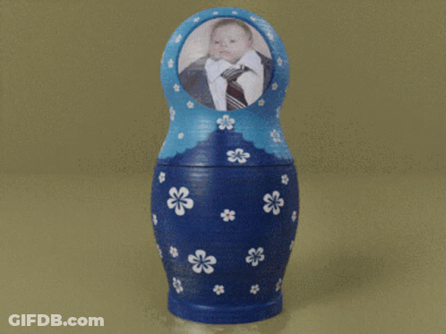 Green Nesting Doll With Man In Suit And Tie GIF
