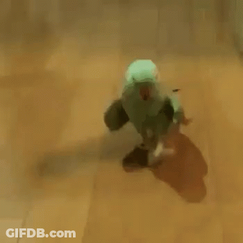 Green Parrot With Red Beak Walking On Wooden Floor GIF