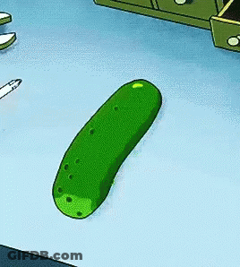 Green Pickle Sitting Next To Pencil GIF