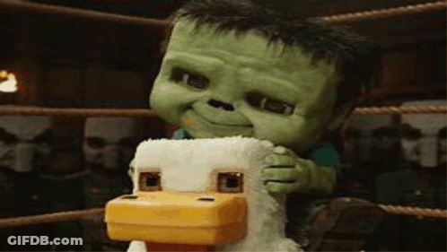 Green Stuffed Animal On Chicken In Boxing Ring GIF