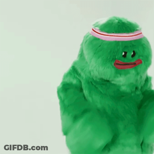 Green Stuffed Animal With Red Heart GIF