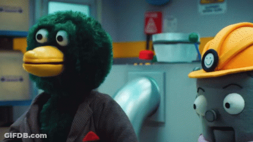 Green Stuffed Animal With Yellow Beak And Hard Hat GIF