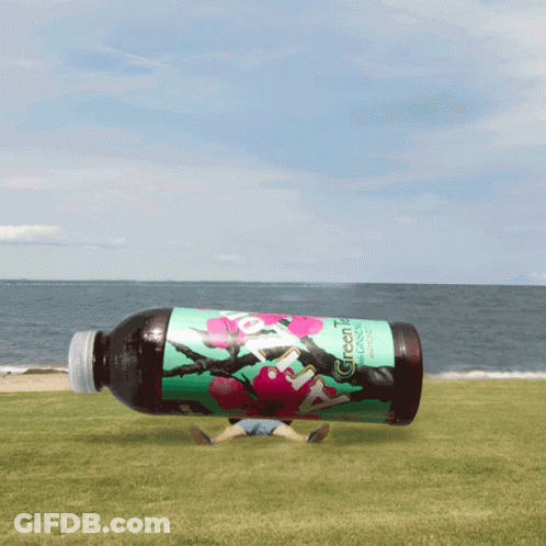 Green Tea Bottle Floating Above Beach GIF