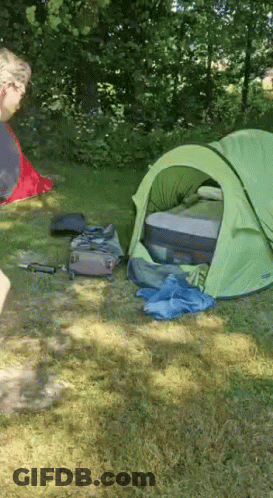 Green Tent In Grass With Suitcase GIF