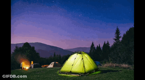 Green Tent Lit Up By Campfire At Night GIF