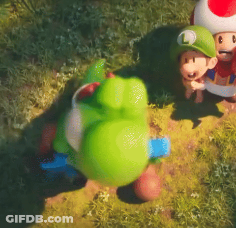 Green Toy With L In Grass GIF