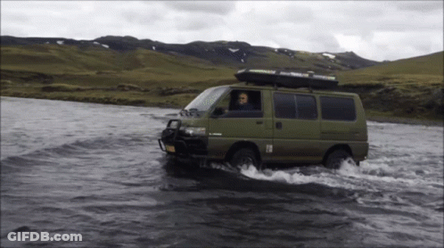 Green Van Driving Through River With Thule Roof Rack GIF