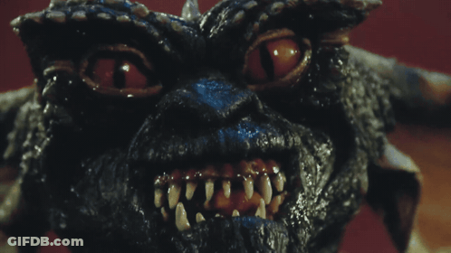Gremlin Face With Bright Red Eyes GIF