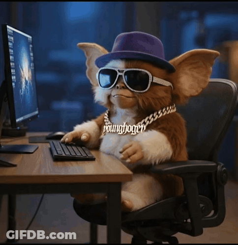 Gremlin In Purple Hat And Sunglasses At Computer Desk GIF