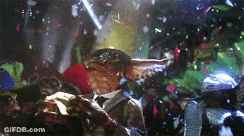 Gremlin In Suit Surrounded By Confetti GIF