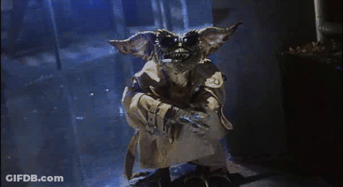 Gremlin In Trench Coat In Dark Hallway GIF