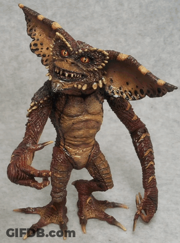 Gremlin Toy With Sharp Claws And Red Eyes GIF