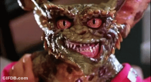 Gremlin With Red Eyes And Pink Shirt GIF