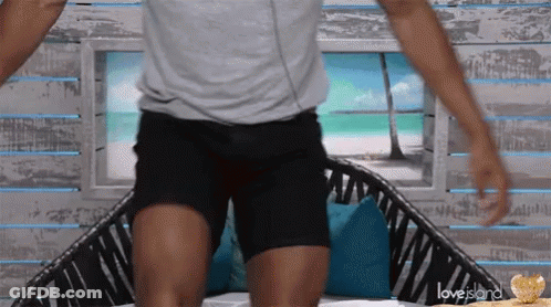 Grey Shirt Black Shorts Man Sitting On Love Island Couch GIF