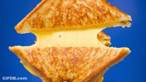 Grilled Cheese Sandwich Cut In Half On Blue GIF