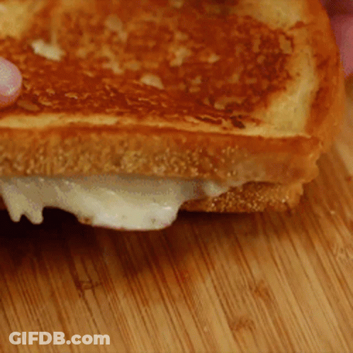 Grilled Cheese Sandwich On Cutting Board GIF