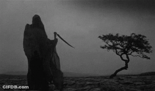 Grim Reaper Standing In Desert Holding Scythe GIF