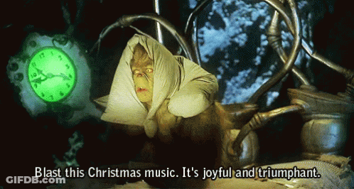 Grinch Says Blast This Christmas Music Joyful And Triumphant In Front Of Clock GIF