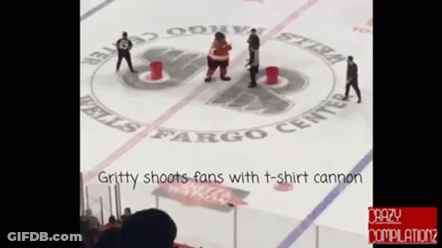 Gritty Shoots Fans With A T-Shirt Cannon During A Hockey Game GIF