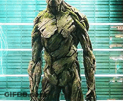 Groot Statue In Front Of Green Wall GIF
