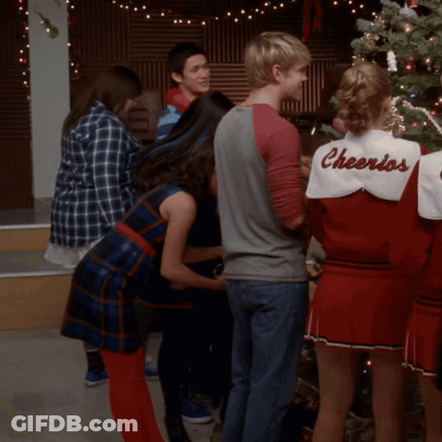 Group Around Christmas Tree Cheerleader In Cheerios Shirt GIF