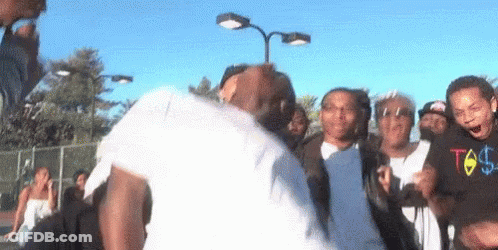 Group Around Dancing Man In White Shirt GIF