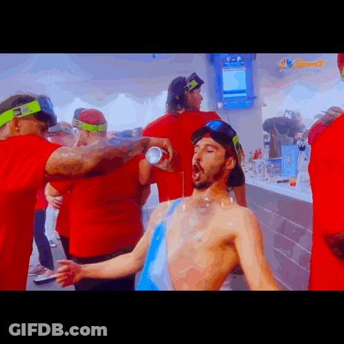 Group Around Man Drinking From NBC Can GIF