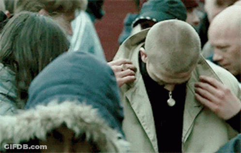 Group Around Man With Necklace GIF