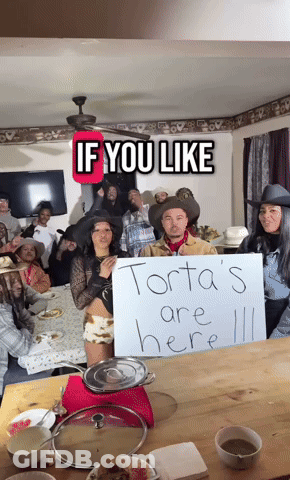 Group Around Table Saying Torta's Are Here GIF
