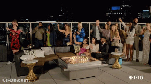 Group Around Table With Netflix Logo GIF