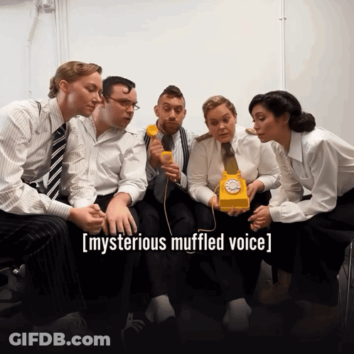 Group Around Yellow Telephone Mysterious Muffled Voice GIF