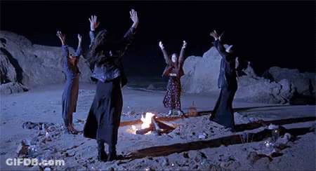Group Dancing Around Fire On Beach At Night GIF